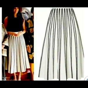 Midi-length ivory sweater skirt with black textured stripes. Elastic waistband.